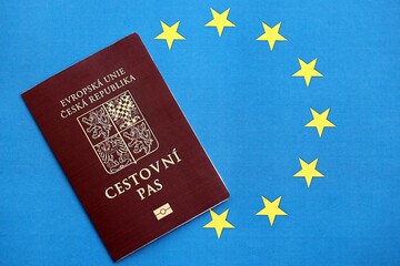 Czech biometrical passport on European Union flag background. Concept of citizenship of Czech Republic