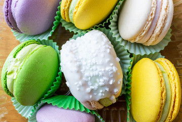 A few colorful French macarons top view background.