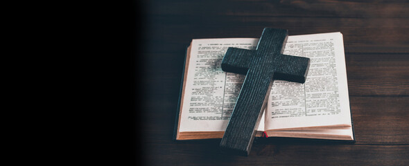 Open book Bible. Wooden cross and crucifix. Prayer. Symbol of Jesus' love for people.