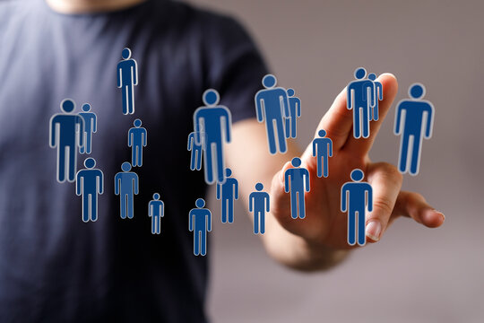 Person interacting with digital human icons, illustrating teamwork, connection, and technology integration in a