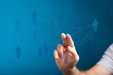 Hand touching digital network of people, representing connection, communication, social media, and teamwork. Co