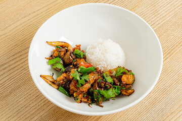 Stir-fried chicken and veggies with herbs, served with rice. Delicious!