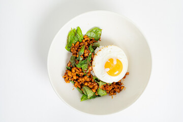 A tasty dish featuring seasoned chicken, spinach, and a rich sunny-side-up egg