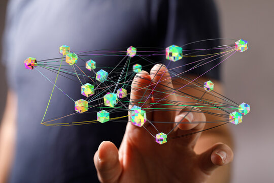Close-up of hand touching digital network connecting points with vibrant, colorful abstract cubes, data visuali