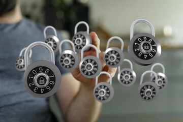 Hand reaching towards a collection of floating padlocks, symbolizing protection, security, and digital safety i