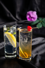 Two enticing cocktails await with vibrant garnishes, perfect for a cozy evening gathering