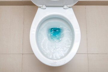 Close-up of a Freshly Flushed Toilet with Blue Water