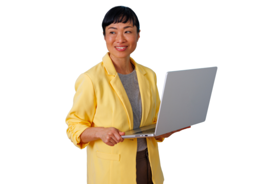Asian businesswoman smiling, holding a laptop. She is connecting, innovating, and working in a modern professional environment