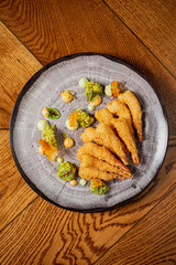 Delicate seafood is plated beautifully with colorful sauces, inviting a culinary experience