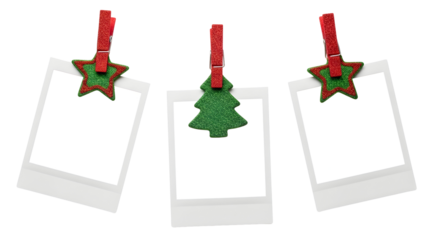 Collection of three blank instant photo prints clipped with festive red stars and a green Christmas tree, isolated on a white background for holiday design