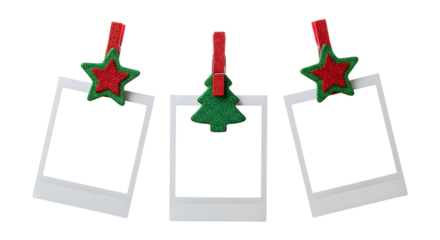 Collection of three blank instant photo prints clipped with festive red stars and a green Christmas tree, isolated on a white background for holiday design