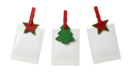 Collection of three blank instant photo prints clipped with festive red stars and a green Christmas tree, isolated on a white background for holiday design