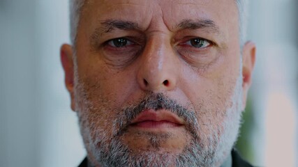 Close up portrait of weary middle aged man with gray beard looking directly at camera, showing fatigue and emotional exhaustion with calm serious expression - Powered by Adobe