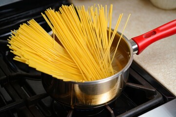 Spaghetti Noodles Cooking in a Stainless Steel Pot on Stove Top