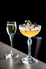 Two beautiful cocktails on a sleek bar countertop create a perfect setting for a night out
