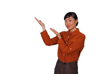Asian woman smiling and presenting with open hands, showing copy space on transparent background for advertising