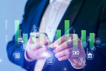 Business professional analyzing marketing trends with digital graphs and icons in a modern office setting