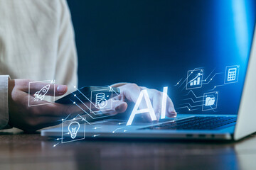 Hands using laptop with AI graphics and data symbols at night in a modern workspace