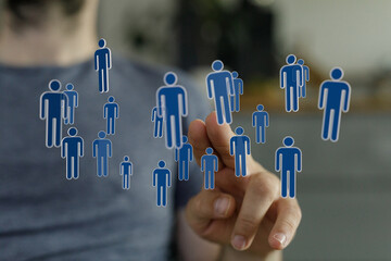 Concept of social network, teamwork and communication. Hand pointing at digital people icons representing conne