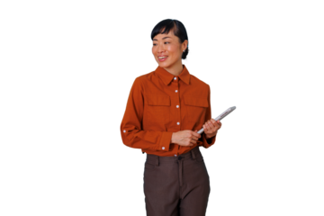 Asian businesswoman smiling looking away holding a tablet, wearing a corporate orange shirt on transparent background