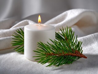Lit white candle beside small pine branch on bright background, creating a serene atmosphere perfect for holiday celebrations and cozy moments of relaxation and reflection