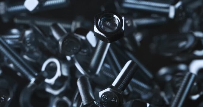 Slow Motion Close Up Shot Of Stainless Steel Nuts And Bolts Suspended In Air, Spinning, Colliding And Reflecting Light With Industrial Precision And Mechanical Energy At 1000 Fps.