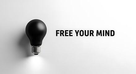 A black light bulb illuminates the phrase free your mind