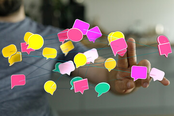 Hand holding connected speech bubbles, representing communication, social networking, and digital...