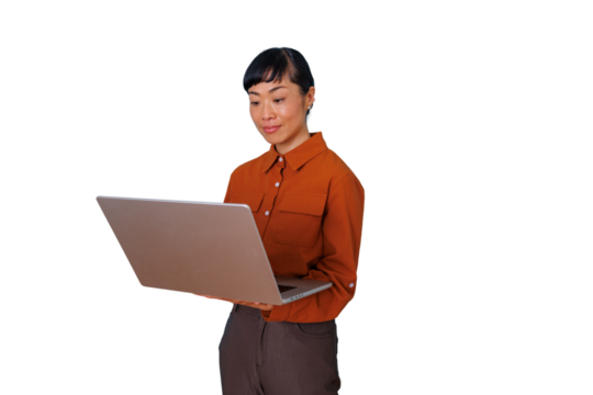 Asian professional woman standing, holding a laptop and looking at the screen, engaging in remote work or online activity