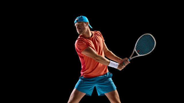 Focused tennis player preparing for backhand return with strong anticipation. Concept of sports photography, dynamic energy, athlete concentration, and performance under pressure.