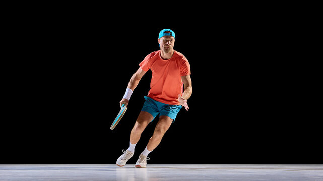 Focused tennis player tracking ball with strong eye contact and balance. Concept of science visuals, human perception study, focus research, and reaction time analysis. - Powered by Adobe