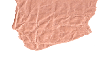 A close-up, top-down view of a torn piece of light brown, crumpled paper with a textured surface and irregular edges isolated on a black background.