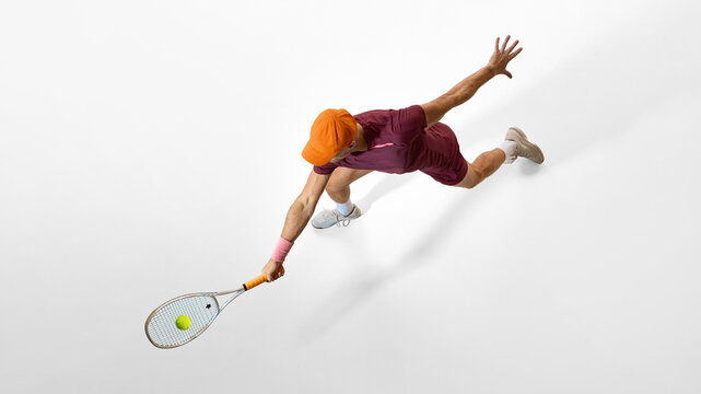 Male tennis player lunging forward for shot showing strong posture and body control. Concept of business leadership, performance focus, goal orientation, and motivational imagery.