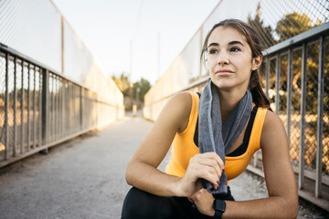 Young woman taking break after workout run