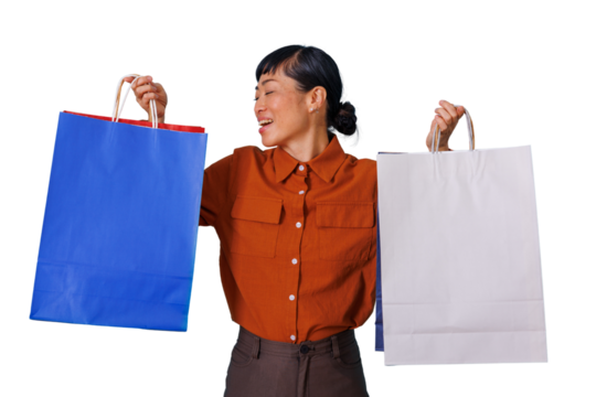 Asian woman happily shopping, carrying blue and white shopping bags, experiencing joy and consumer satisfaction