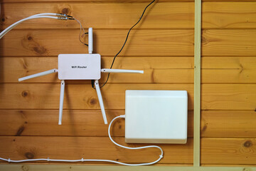 Internet router with antennas on wooden wall country house. Wi-Fi router