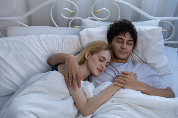 Couple hold hand express love, sweet connection shown in bed, wrapped in cozy blanket sharing tender moment of affection