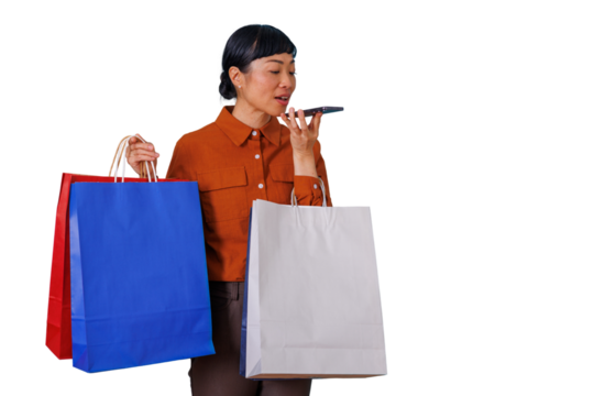 Asian woman shopping using voice assistant on phone while holding colorful shopping bags, transparent background - Powered by Adobe