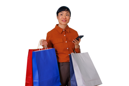 Asian woman holding shopping bags and smartphone, enjoying shopping, consumerism, and retail sales on transparent background - Powered by Adobe