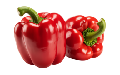 Two vibrant red bell peppers with green stems isolated on a plain black background
