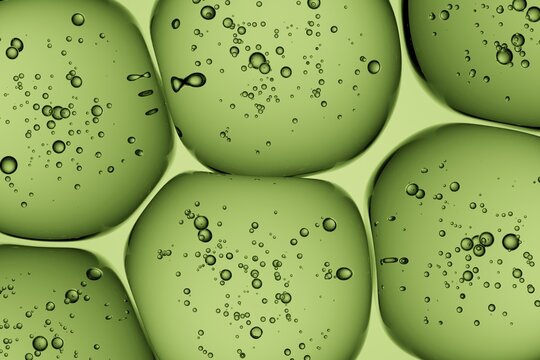 Close-up of translucent green gel infused with bubbles, ideal for eco-luxury campaigns, biotech presentations, and refreshing abstract design work