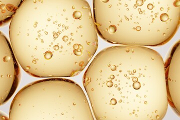 Golden translucent capsule-like forms with internal microbubbles, ideal for supplement branding, wellness advertising, and premium macro visuals