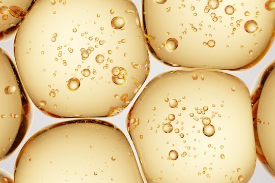 Golden translucent capsule-like forms with internal microbubbles, ideal for supplement branding, wellness advertising, and premium macro visuals