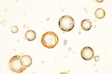 Sparkling golden spheres with rising microbubbles, ideal for luxury branding, premium beverage ads, and mesmerizing abstract background compositions