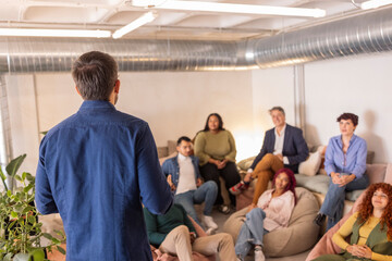 Speaker presenting to diverse casual business audience