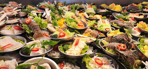 A variety of  dim sum dishes are arranged in stainless steel cups for customers to choose from. Small dishes, mostly steamed before eating. Brunch is often served with sweet - sour sauce. fusion food
