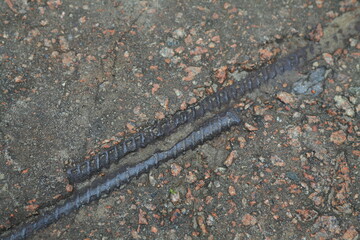 Concrete wall texture with rough surface and natural imperfections. Grey industrial background for design, construction concepts and architectural materials.