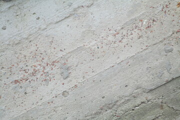 Concrete wall texture with rough surface and natural imperfections. Grey industrial background for design, construction concepts and architectural materials.