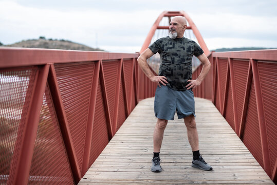 65-year-old man, full-body wide-frame portrait after running