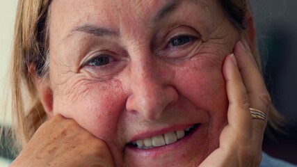 Elderly woman smiling softly with eyes closed, close up of joyful aging face expressing tenderness, warmth, and life experience through genuine emotion